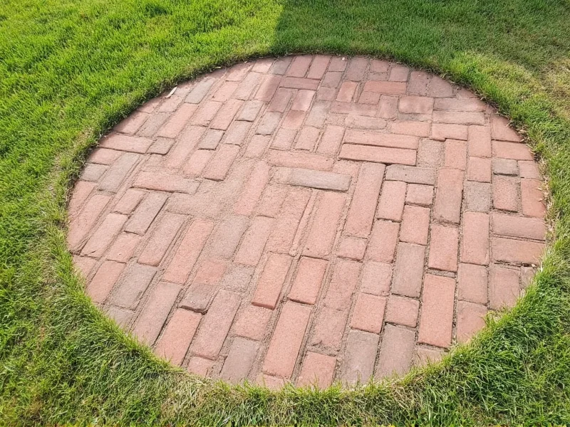 Reclaimed brick patio materials arranged on grass