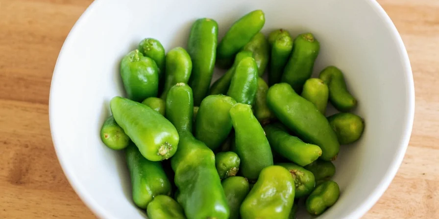 Fresh serrano peppers on a wooden table
