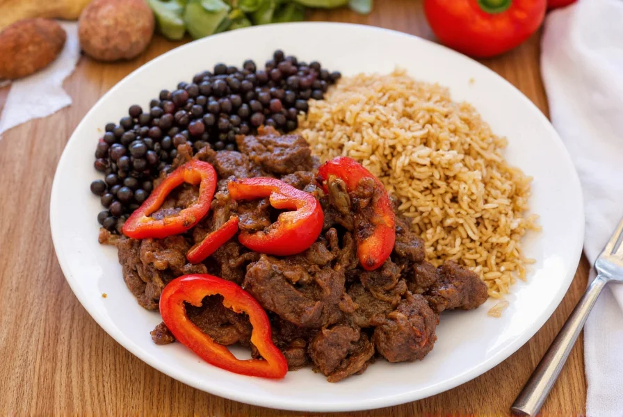 Jamaican pepper steak served on white plate with rice and peas, featuring vibrant red bell peppers and onions, cooked in cast iron skillet