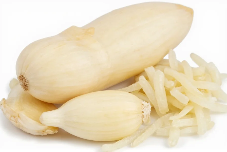 Garlic cloves next to measuring spoons for visual reference