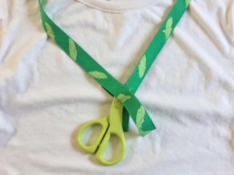 Recycled t-shirt and scissors arranged for homemade sling project