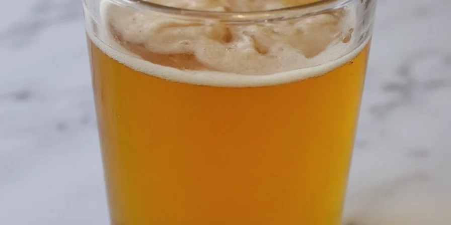 Homebrewer stirring a pot of boiling wort with spices
