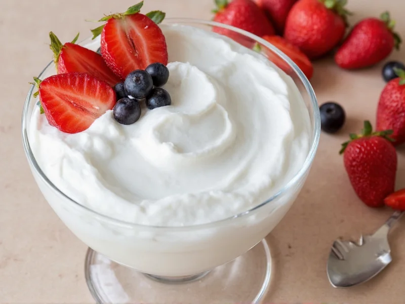 Homemade whipped cream in glass bowl with fresh berries