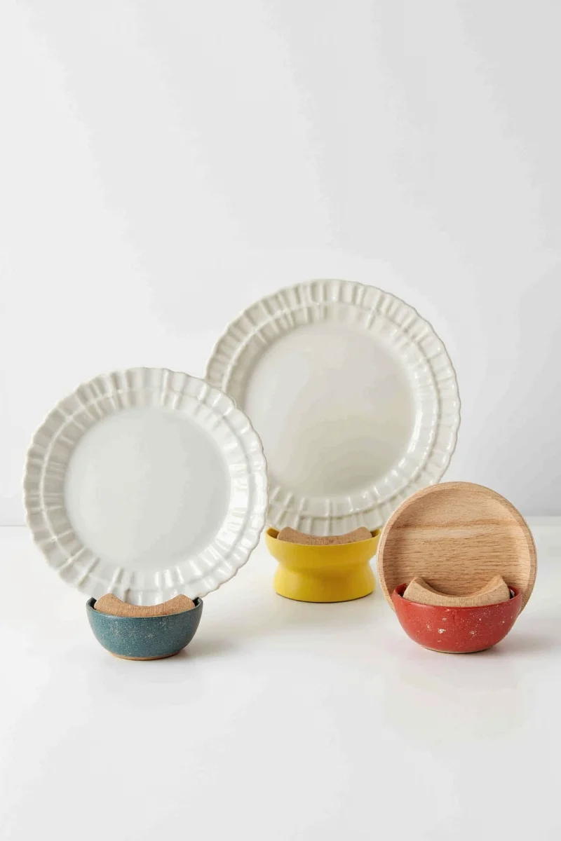 A multi-tier bamboo plate stand decorated with Christmas-themed plates during December.