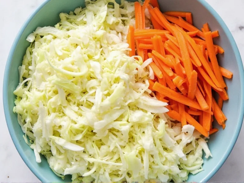 Fresh shredded cabbage and carrots in mixing bowl