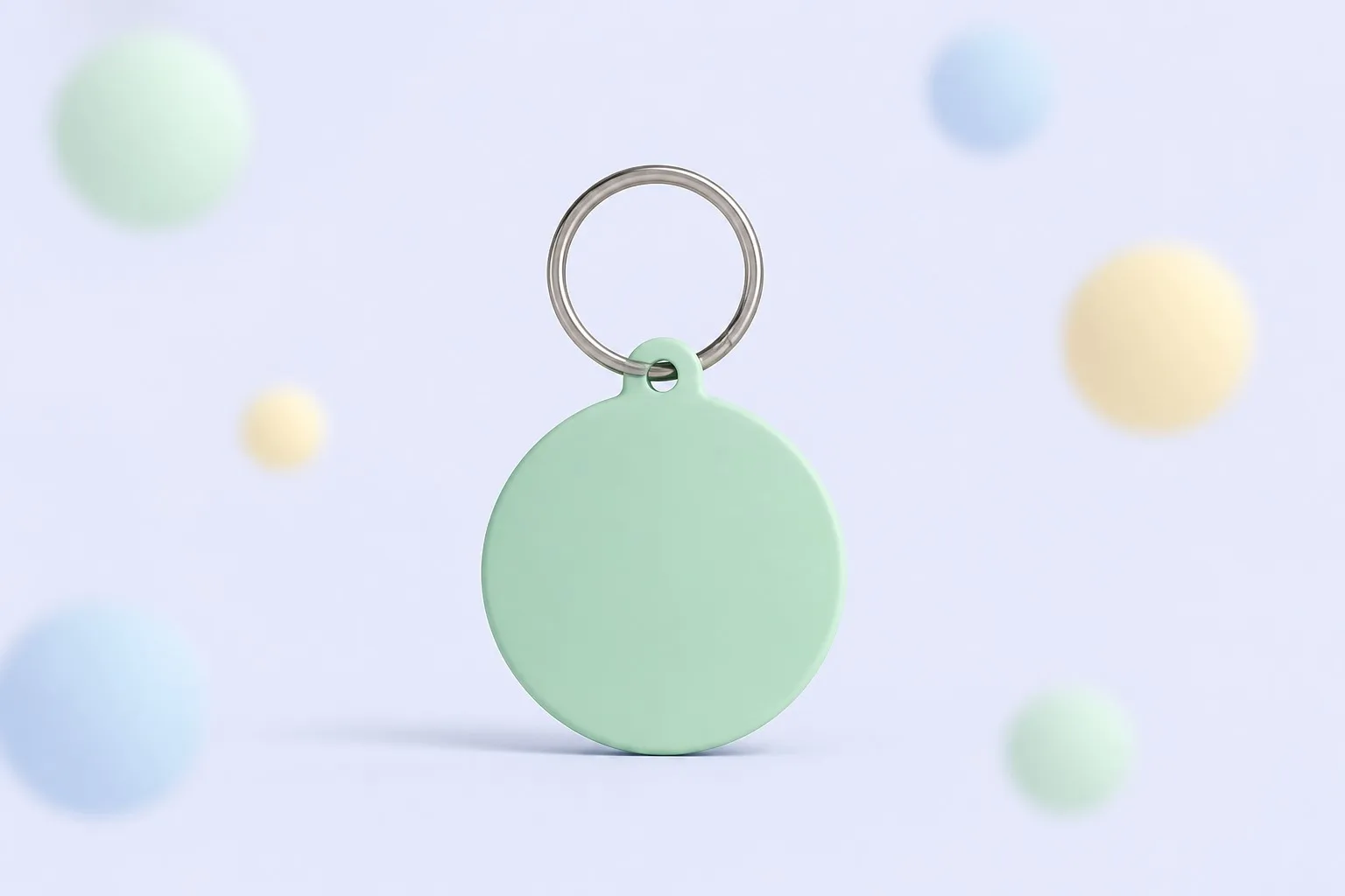Mint keychain tag surrounded by soft pastel bokeh spheres