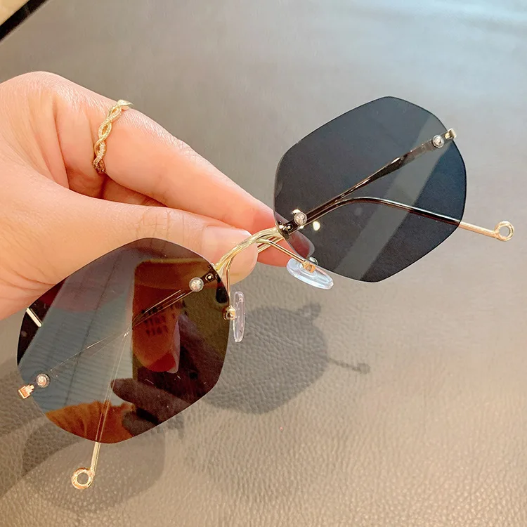 

Lmamba Fashion Rimless Irregular Polygon Sun Glasses River Metal Frameless Trend Women Sunglasses 2021