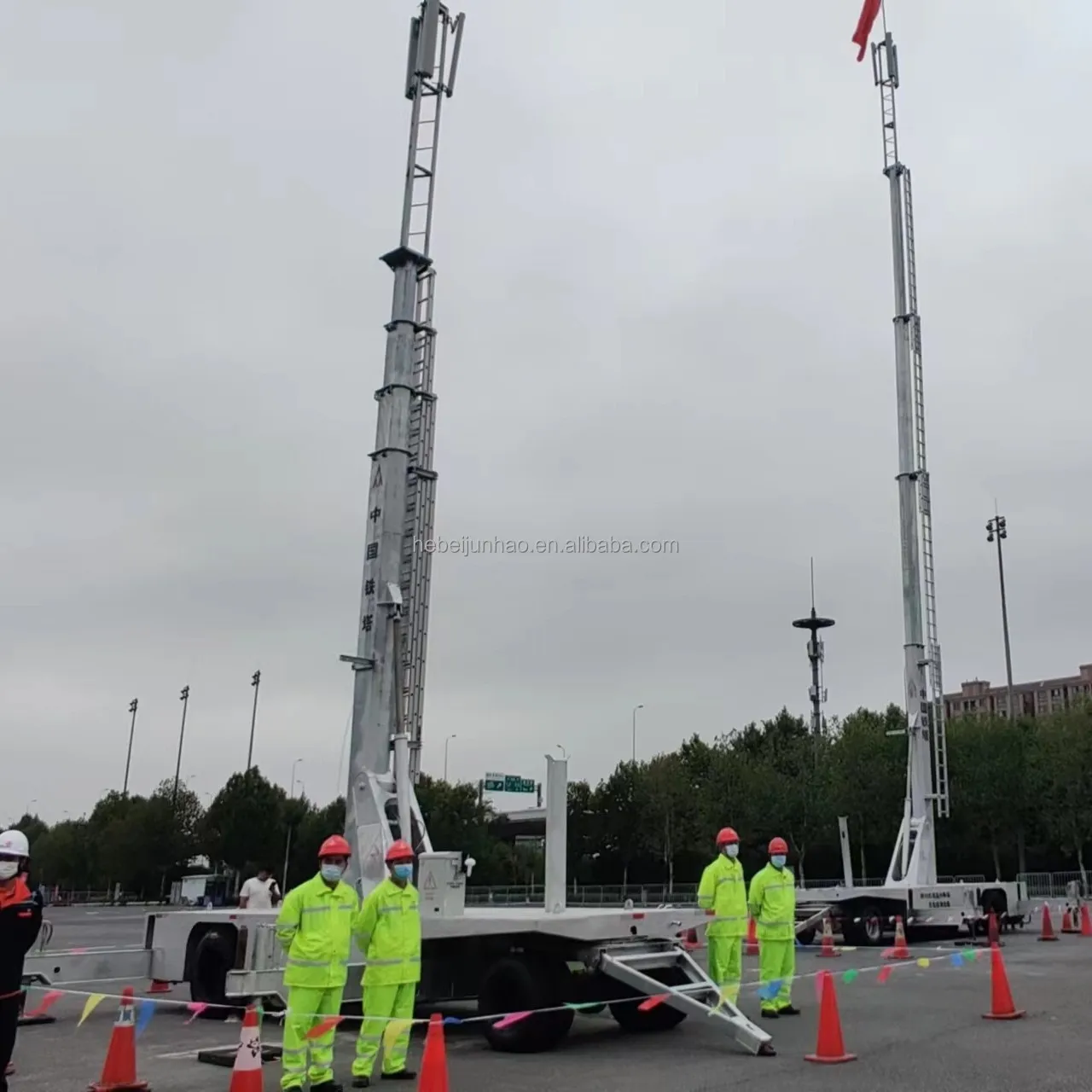 Two mobile lifting towers deployed at a controlled outdoor worksite