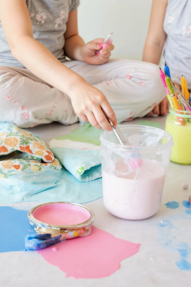 Kids' bedroom with sky blue walls and rainbow toys