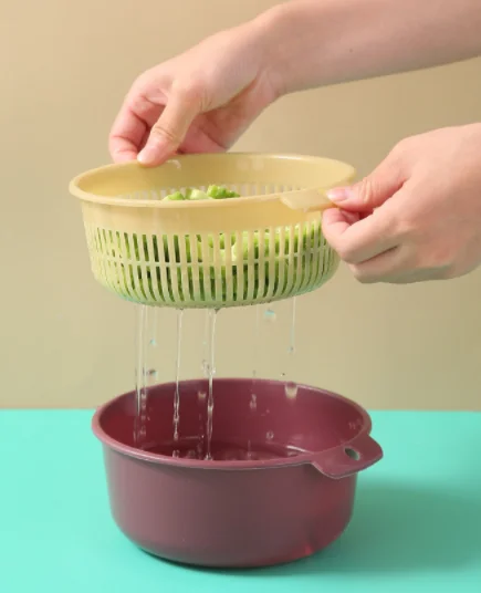 

The vegetable washing basket is portable and multi-purpose Drip basket kitchen plastic Double round fruitsink drain basket
