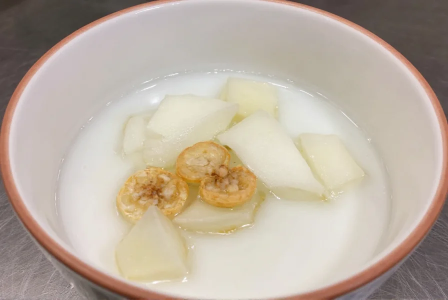 Close-up of whole cloves steeping in clear glass teapot with steam rising, showing the traditional preparation method for clove water recipe