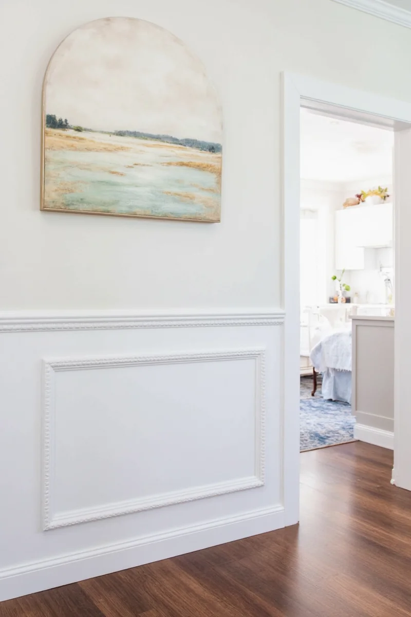 Before: plain entryway wall