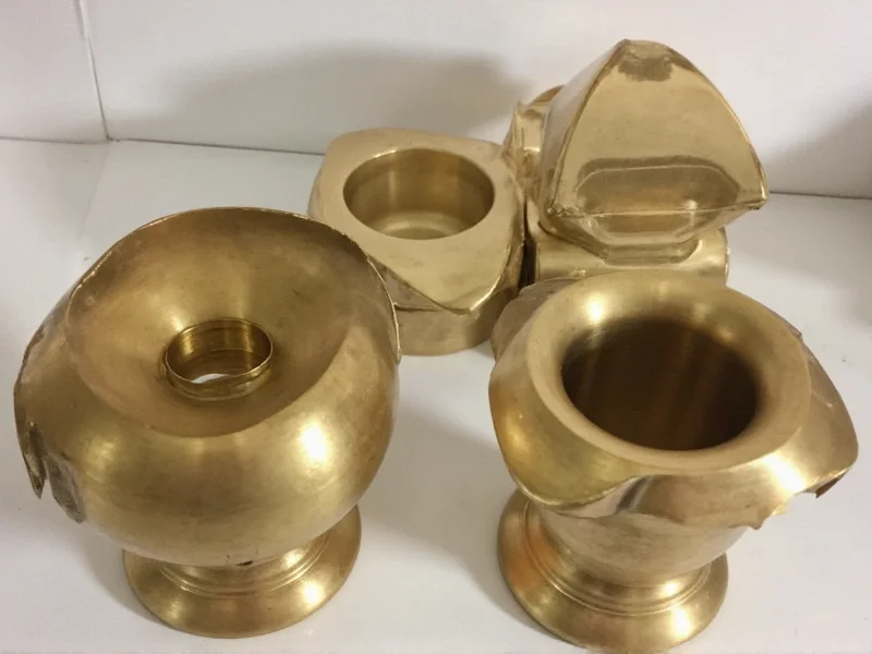 Polished brass items with protective wax coating