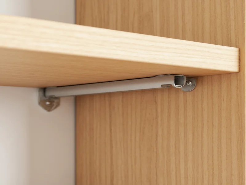 Close-up of hidden metal bracket inside wooden shelf support
