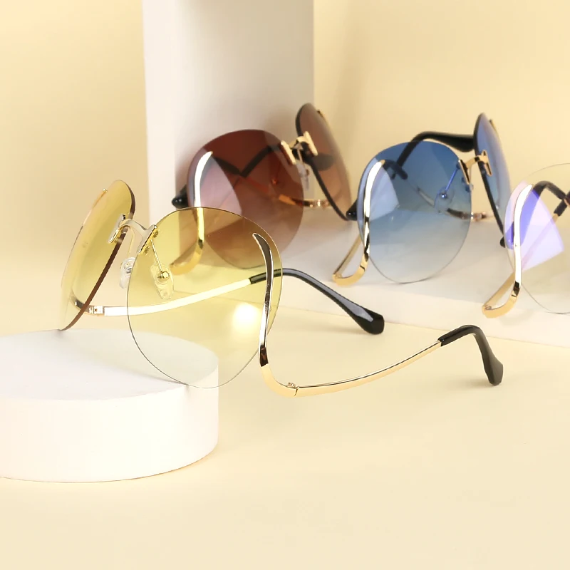 

Rimless Curved leg Sunglasses Fashion Metal Sunglasses for Women Color Ocean Lens Trend Cutting Sunglasses 2021