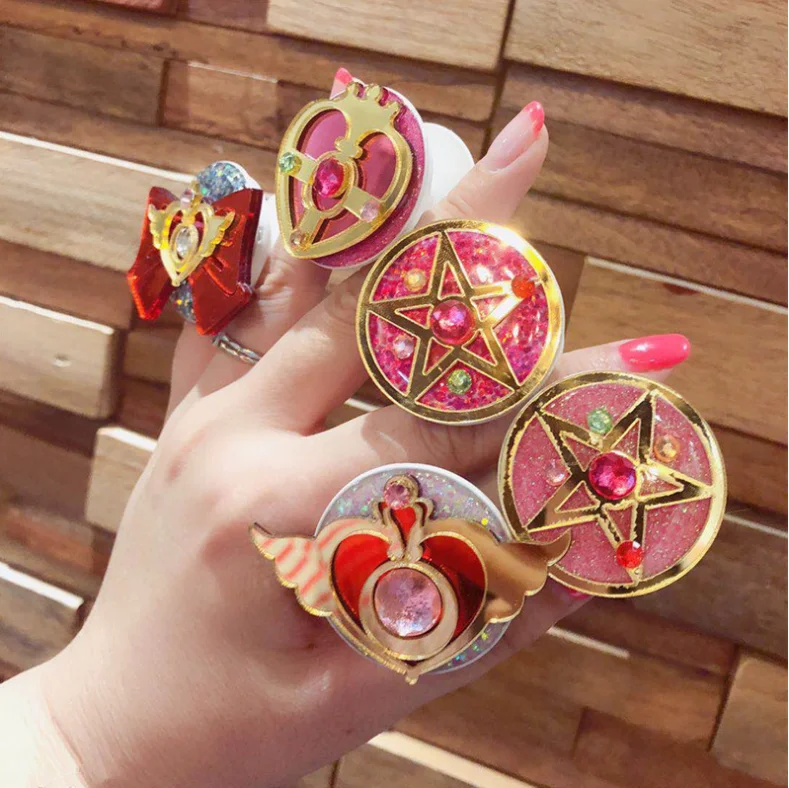 

2022 new arrivals sailor moon phone holder mobile stand and custom mobile holder phone sockets phone with logo