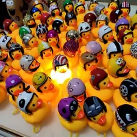 

2019 hot sale in UK promotional toys cute yellow rubber flashlight bike bell horn light MOTO duck with helmet