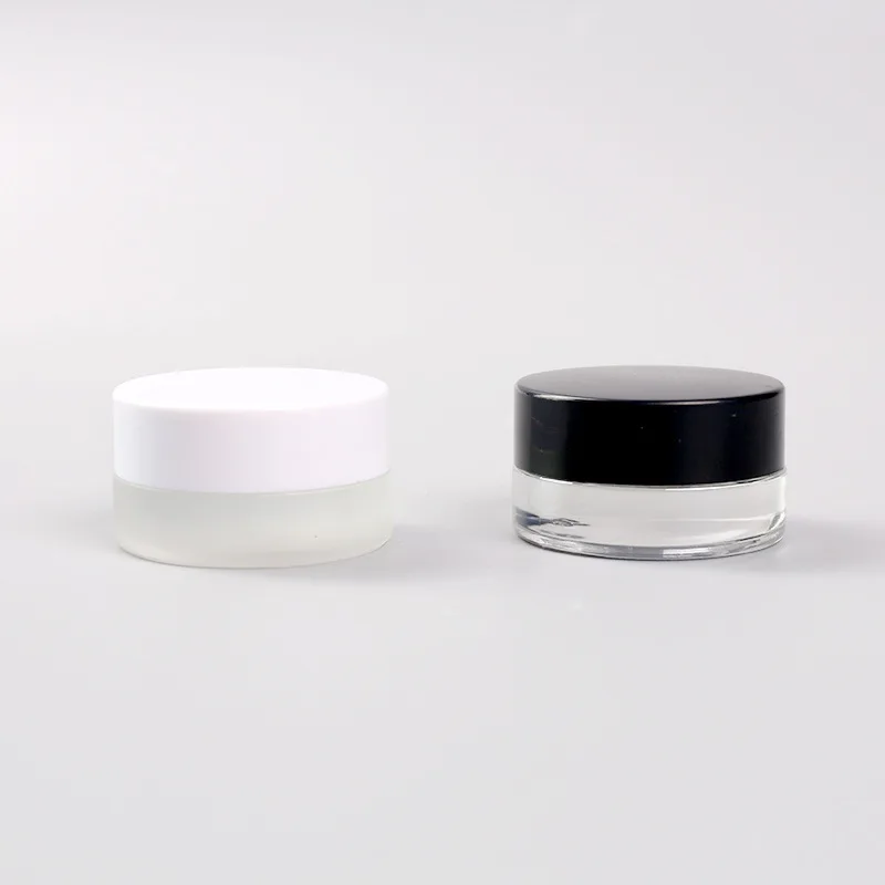 

Wholesale in Stock Small Empty 3g 5g Clear Frosted Eye Cream Lip Balm Glass Jar with White or Black Lids