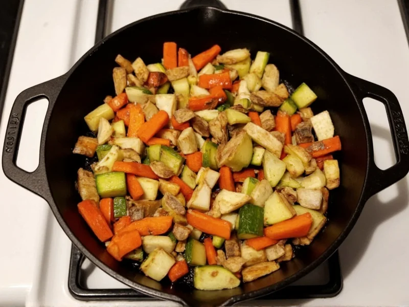 Vegetable scraps roasting in cast iron skillet before broth making