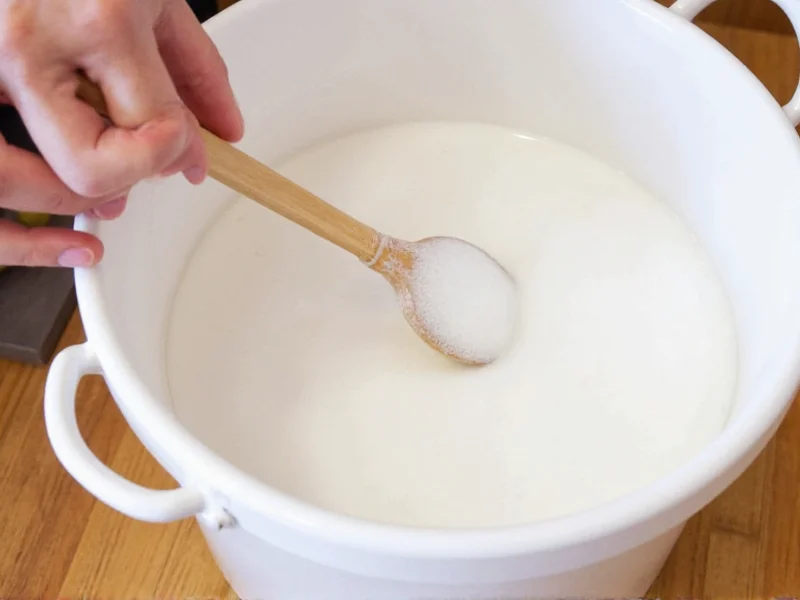 Hands stirring homemade laundry soap in large bucket with wooden spoon