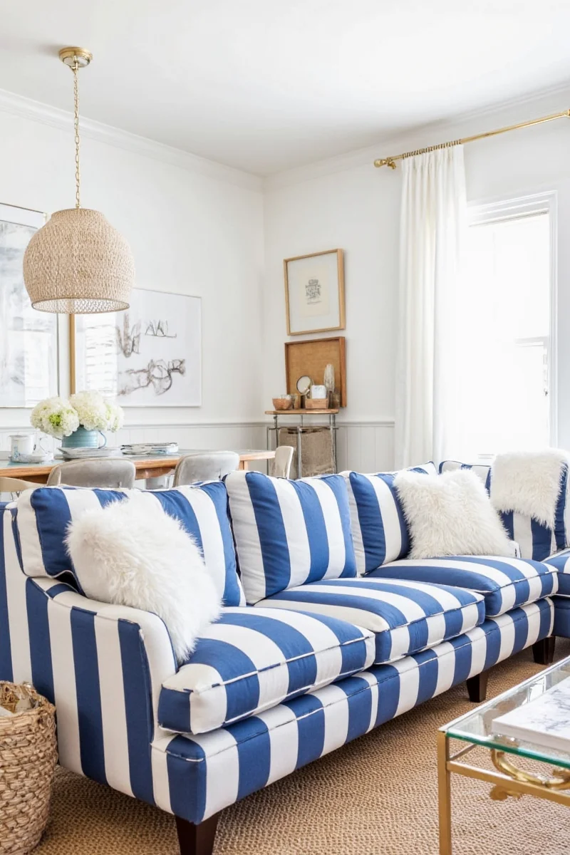Kids playing on a blue and white striped sofa
