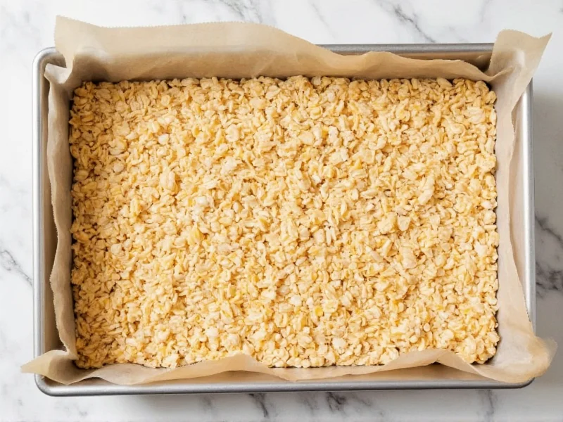 Homemade rice krispie squares in parchment-lined pan