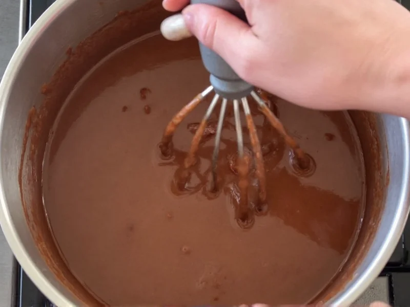 Beating homemade fudge mixture in saucepan
