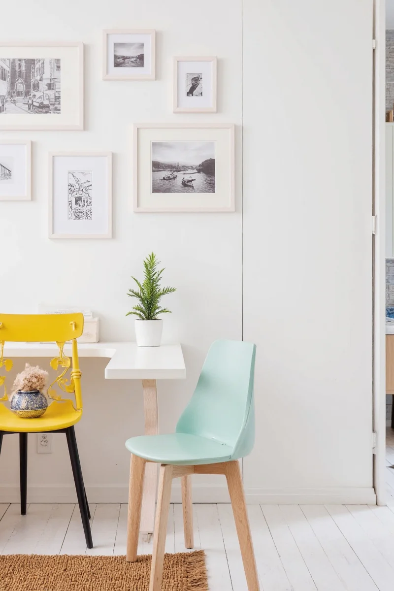 Floating wooden shelves displaying framed children's drawings and small figurines