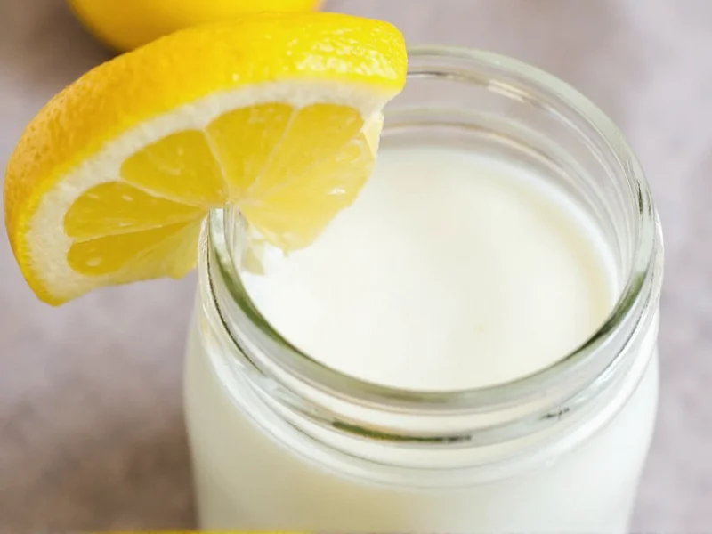 Fresh homemade buttermilk in glass jar with lemon wedge