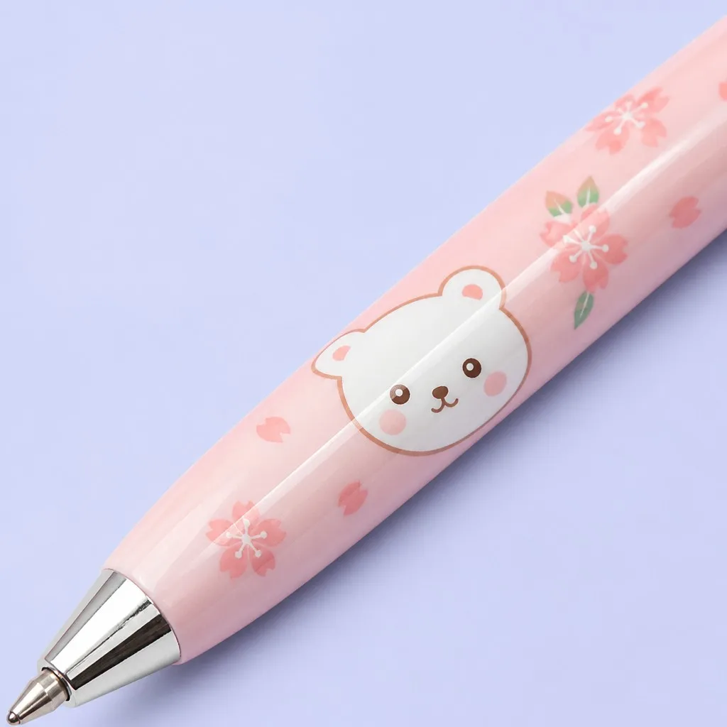 Close-up of pink ballpoint pen with bear and cherry blossom pattern