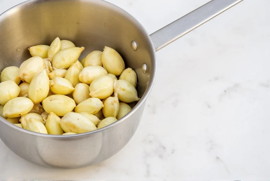 Close-up of fresh garlic cloves next to measured minced garlic in teaspoon