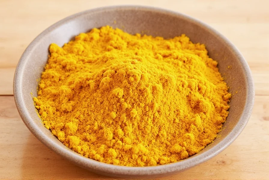 Fresh turmeric root and ginger side by side on wooden cutting board