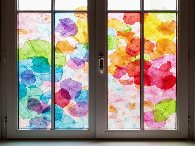 Colorful tissue paper suncatchers on window