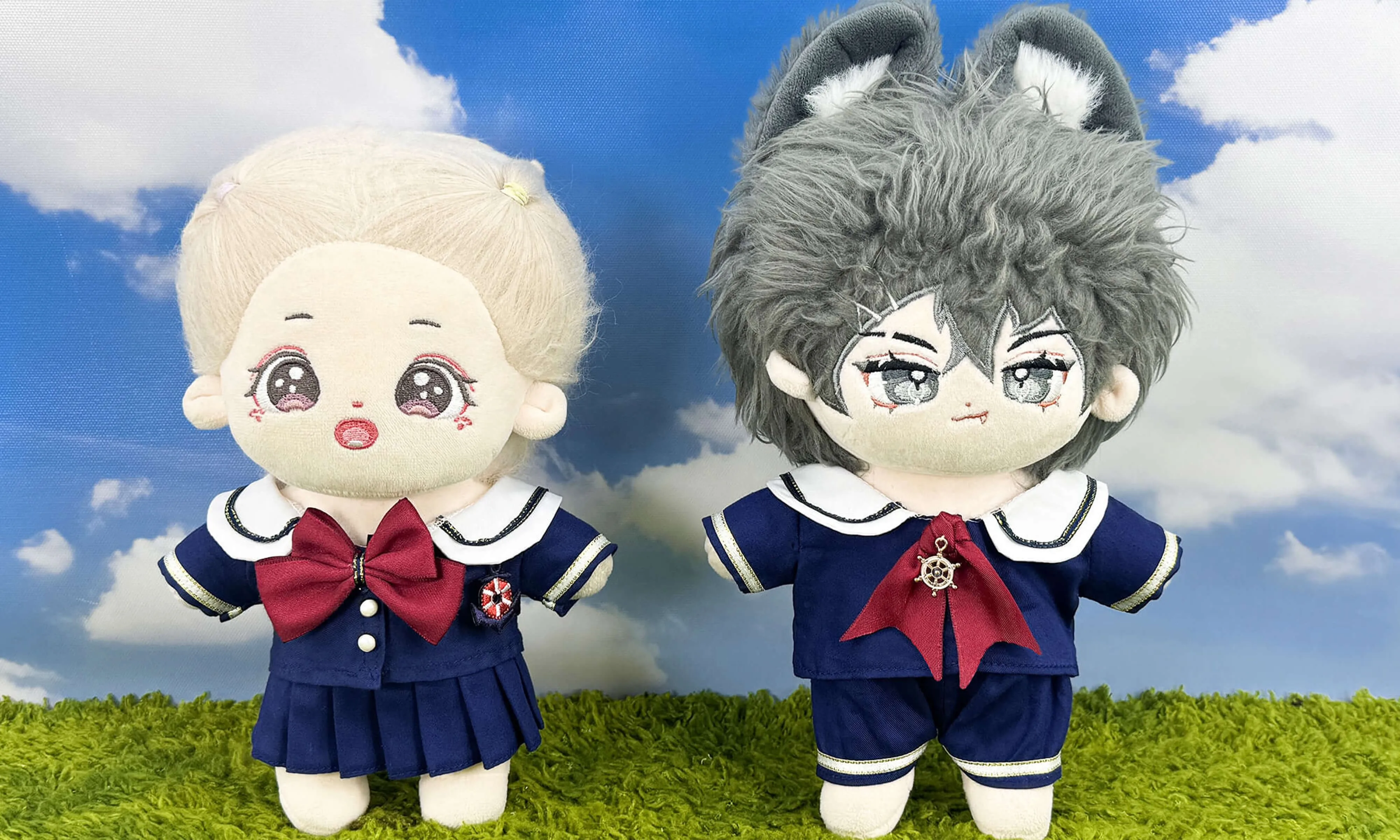 Two plush dolls wearing completed sailor suits on display
