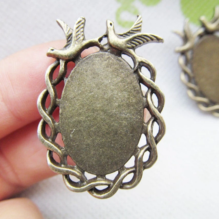 

Newly Launched In 2021 37mmx27mm Tray With Wings Couple Peace Bird Oval Metal Bezel Tray Pendant, Antique silver tone/antique bronze