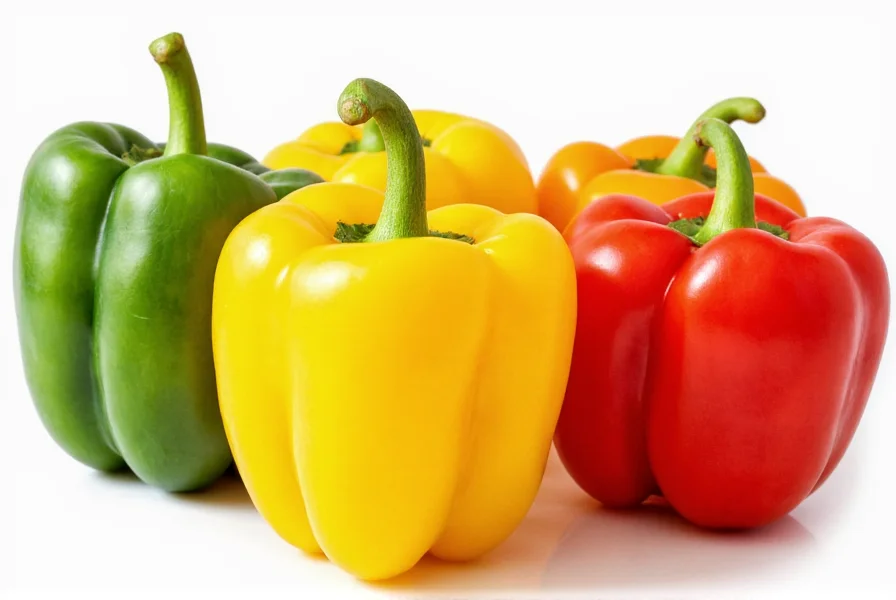 Colorful array of bell peppers showing nutritional differences between green, yellow, orange, and red varieties