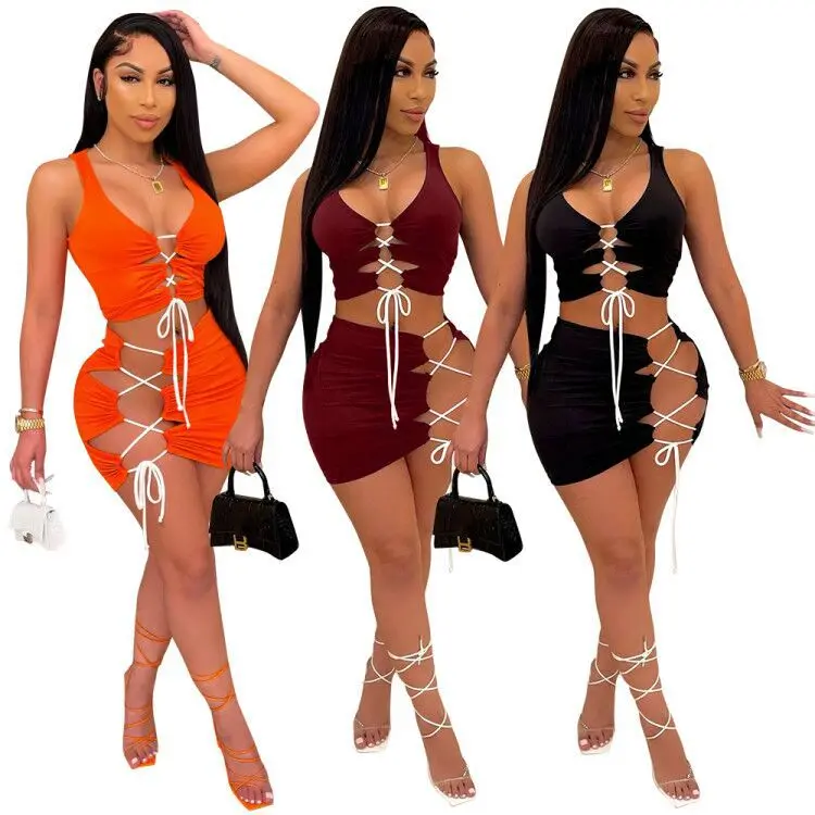 

2021 Hot Selling Casual Solid Color Lace Up Mini Skirt Two Piece Set Sexy Hollow Out Sleeveless Women 2 Piece Skirt Outfit