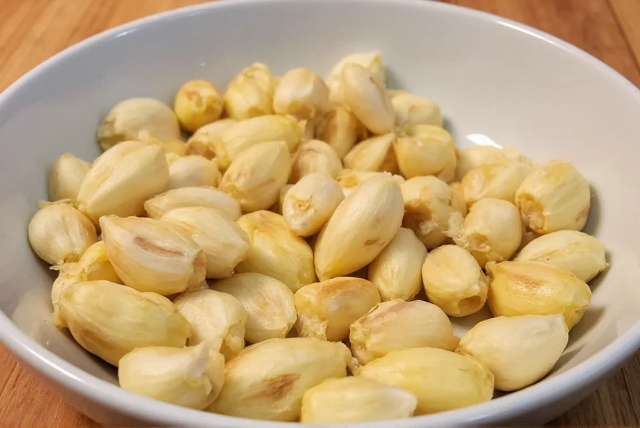 Perfectly roasted garlic cloves on baking sheet with golden brown color