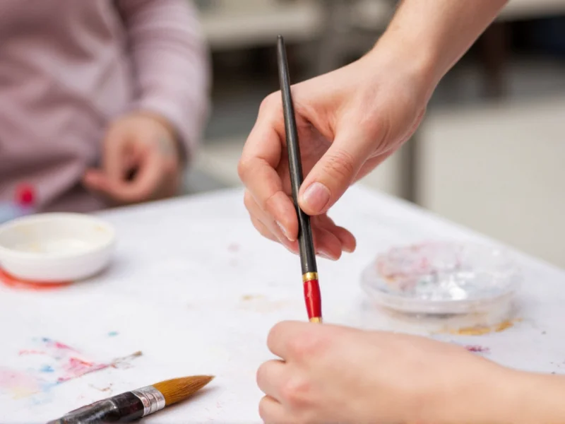 Hand holding paintbrush during Michaels craft workshop