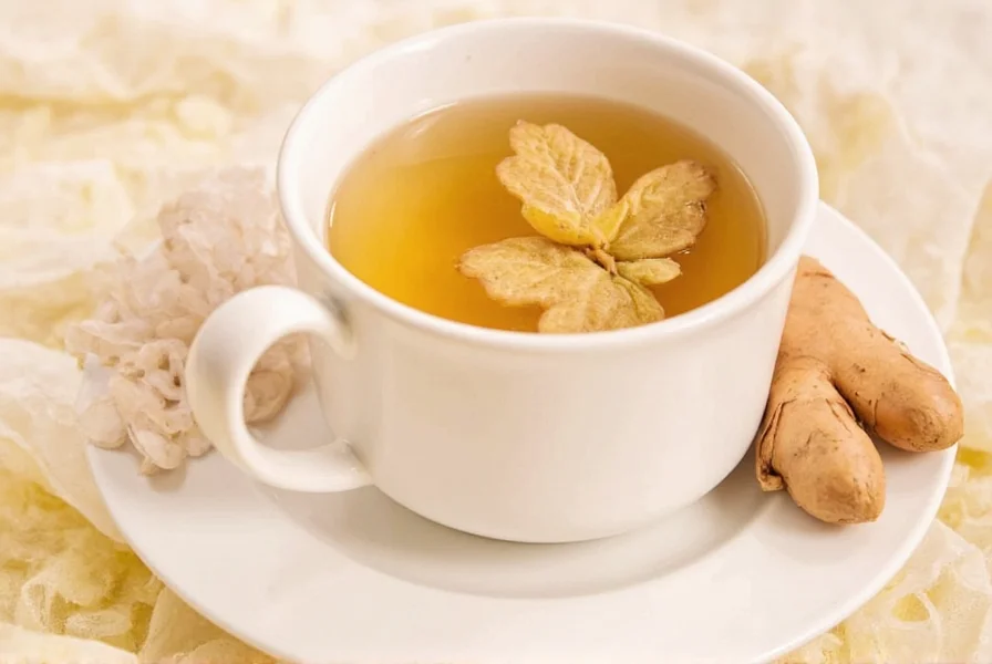 Fresh ginger root and brewed ginger tea cup