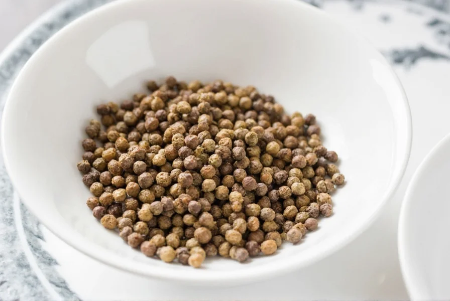 Freshly ground black pepper on a wooden cutting board