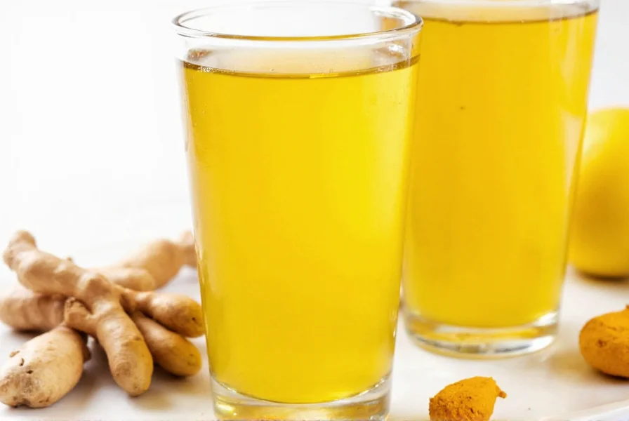 Fresh turmeric ginger shots in small glass bottles with lemon slices