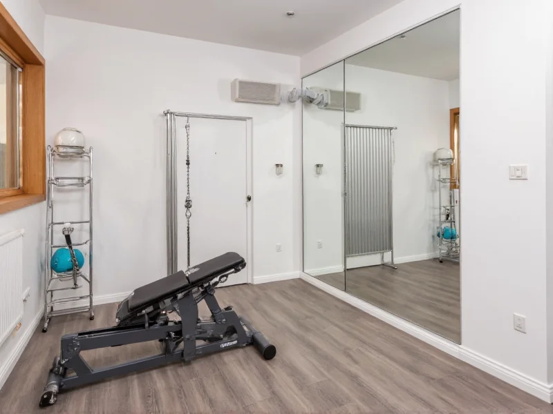 Small apartment corner transformed into efficient home gym layout