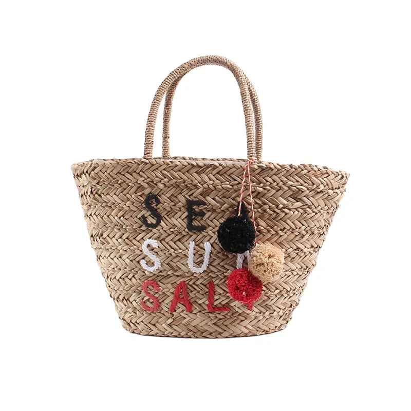 

Fashionable Handmade seaGrass Woven Handbags Rattan Summer Beach Bag Drawstring Straw Bag With Colorful Tassel Wool Ball