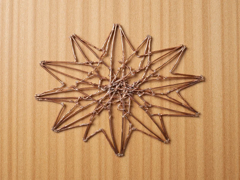 Geometric string art on wooden board with nails