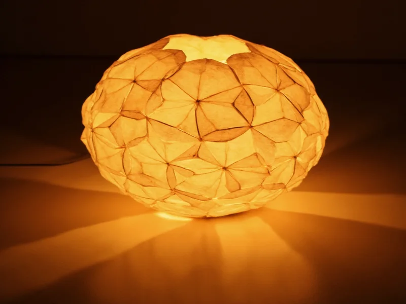 Handmade geometric paper lamp casting warm light