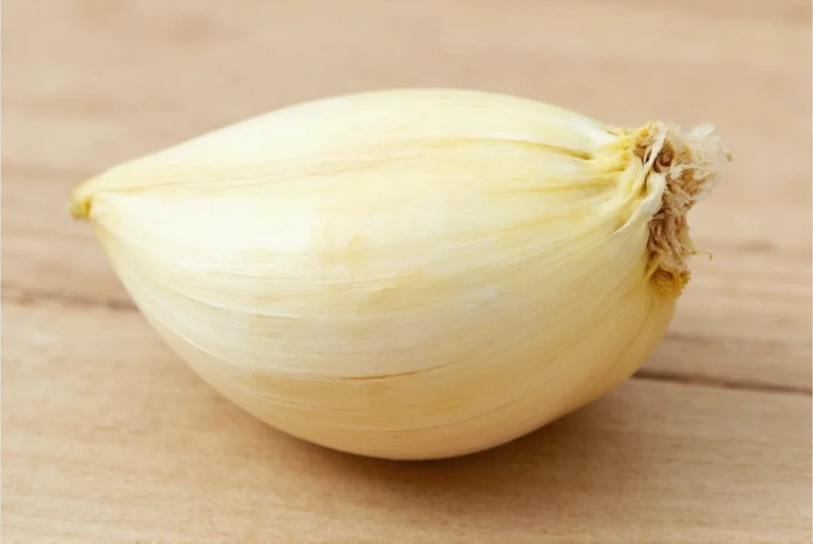 Garlic cloves next to measuring spoons showing conversion equivalents