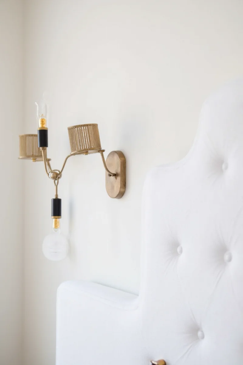 Minimalist sconces in a neutral-toned bedroom