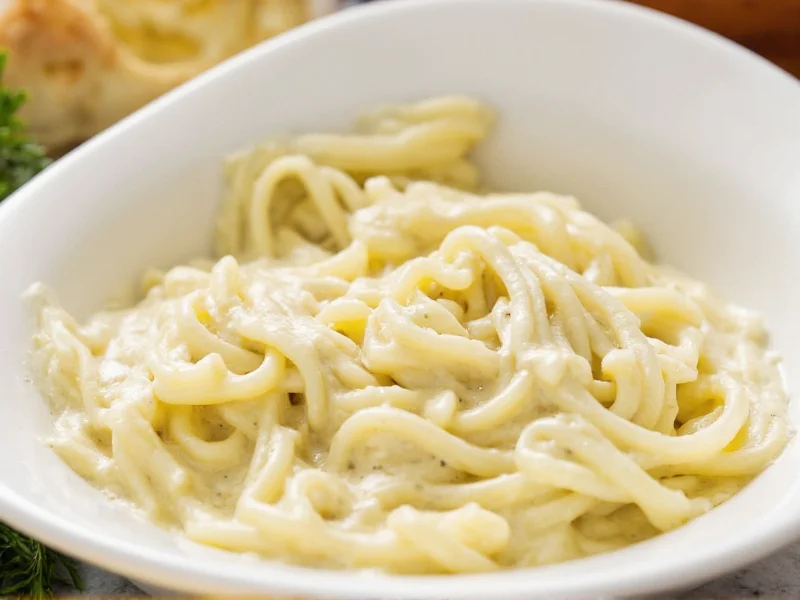 Creamy homemade alfredo sauce in white bowl