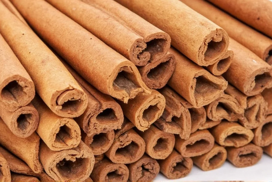 Close-up comparison of cassia cinnamon sticks versus Ceylon cinnamon sticks showing the thicker, harder bark of cassia